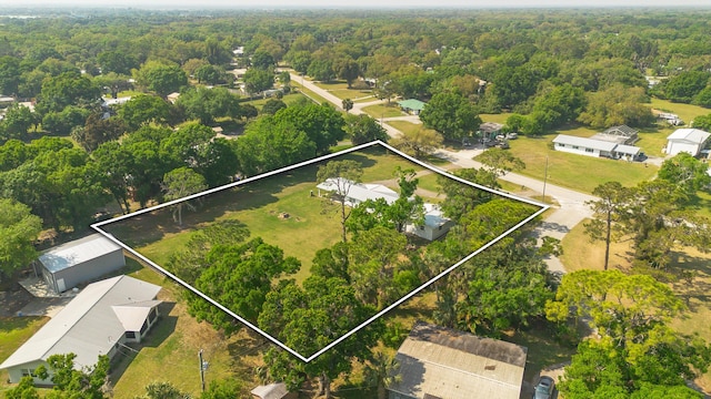 birds eye view of property featuring a view of trees