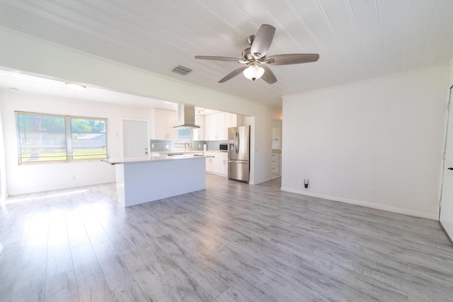 unfurnished living room featuring visible vents, a ceiling fan, and light wood finished floors