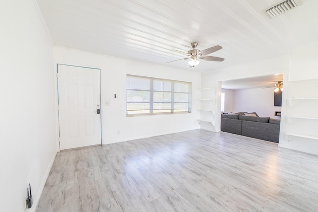 unfurnished living room featuring visible vents, wood finished floors, crown molding, baseboards, and ceiling fan