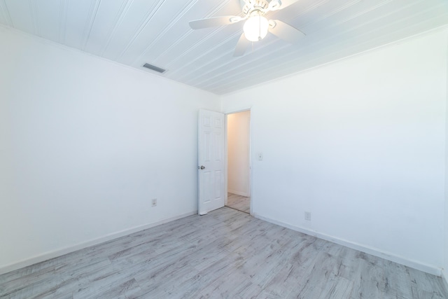 empty room with visible vents, baseboards, light wood-style floors, and a ceiling fan