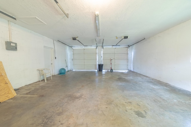 garage with concrete block wall and electric panel