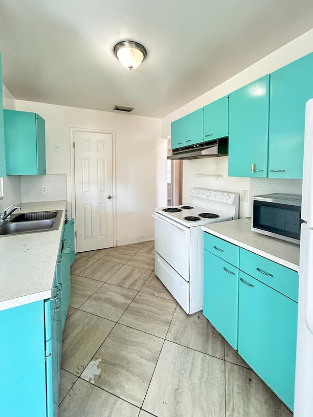 kitchen with white appliances, blue cabinetry, a sink, light countertops, and under cabinet range hood