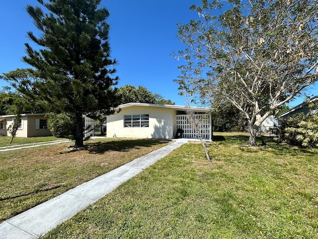 view of front of house featuring a front lawn and stucco siding