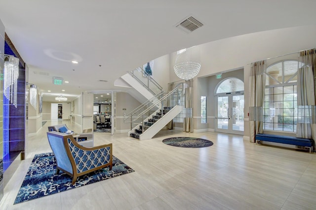 interior space with stairway, a notable chandelier, french doors, and visible vents