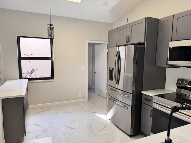 kitchen featuring light stone counters, baseboards, marble finish floor, and appliances with stainless steel finishes