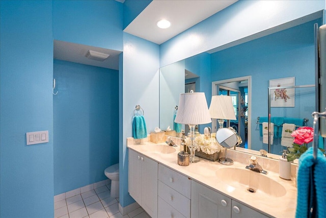 bathroom featuring a sink, visible vents, toilet, and tile patterned flooring