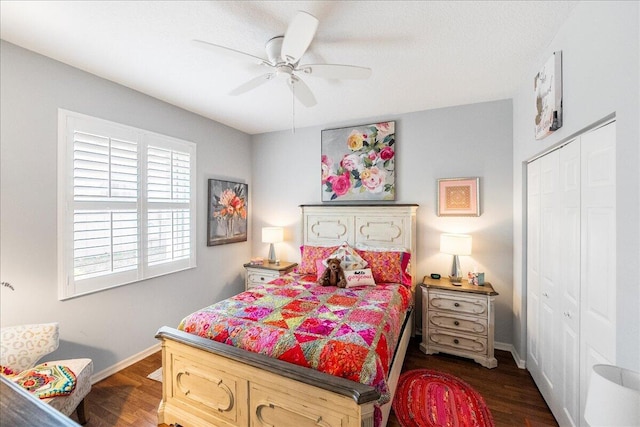 bedroom featuring a closet, dark wood finished floors, baseboards, and ceiling fan