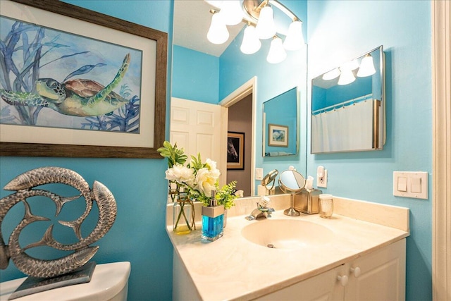 bathroom featuring toilet and vanity