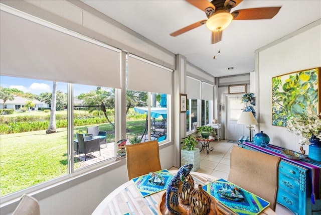 sunroom featuring ceiling fan