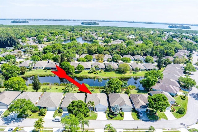 bird's eye view with a residential view and a water view