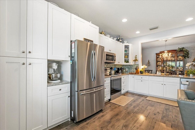 kitchen featuring glass insert cabinets, white cabinets, dark wood-style floors, and appliances with stainless steel finishes