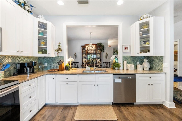 kitchen featuring visible vents, a sink, electric range oven, stainless steel dishwasher, and dark wood-style flooring