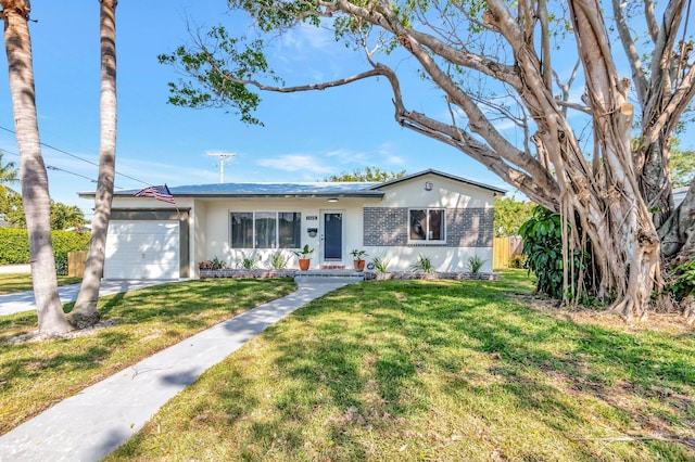 single story home featuring a front yard, an attached garage, and fence