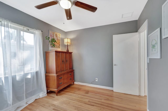 bedroom featuring a ceiling fan, light wood-type flooring, and baseboards