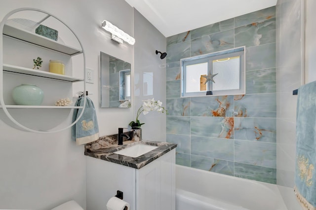 bathroom featuring washtub / shower combination and vanity