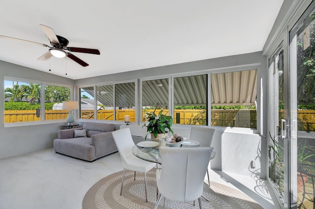 sunroom with a wealth of natural light and ceiling fan