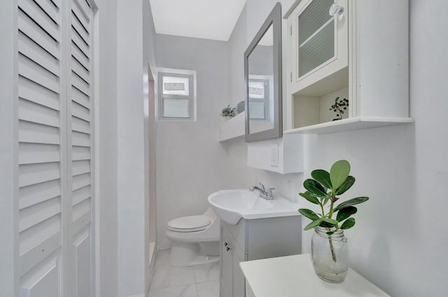 bathroom featuring vanity, toilet, and marble finish floor