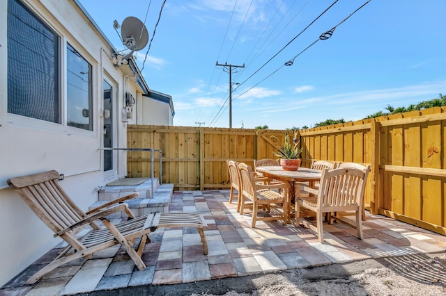 view of patio featuring outdoor dining area and fence