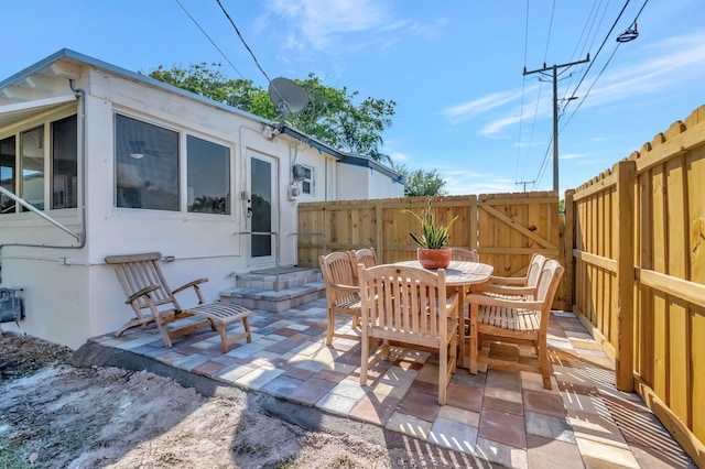 view of patio / terrace featuring outdoor dining area and fence