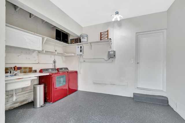 interior space with a sink, speckled floor, and independent washer and dryer