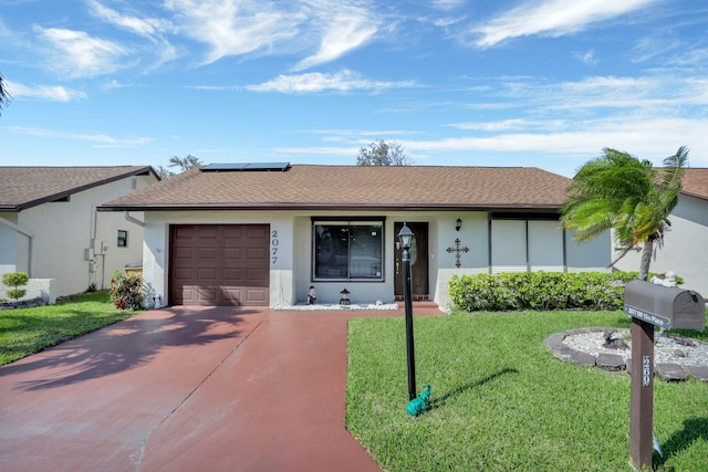 ranch-style home with solar panels, stucco siding, concrete driveway, a front lawn, and a garage