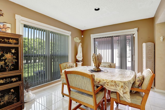 dining room with light tile patterned floors and a textured ceiling