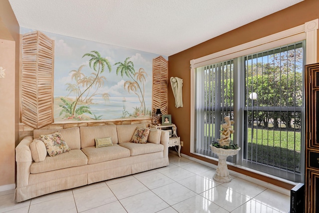 living room featuring tile patterned flooring, a textured ceiling, and baseboards