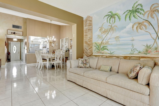 living area featuring a chandelier and visible vents