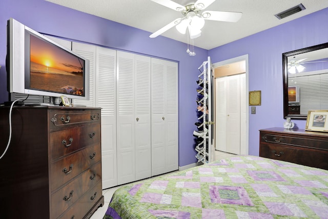 bedroom featuring a ceiling fan, visible vents, and a closet