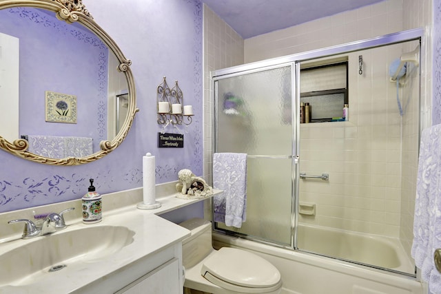 full bathroom with shower / bath combination with glass door, vanity, and toilet