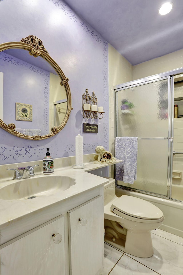 bathroom featuring vanity, toilet, combined bath / shower with glass door, and marble finish floor