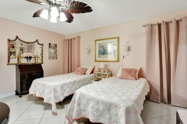 bedroom with ceiling fan, baseboards, and light tile patterned flooring