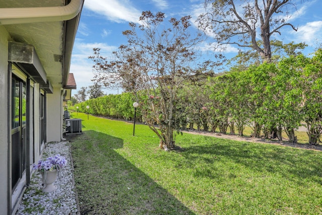 view of yard featuring central air condition unit