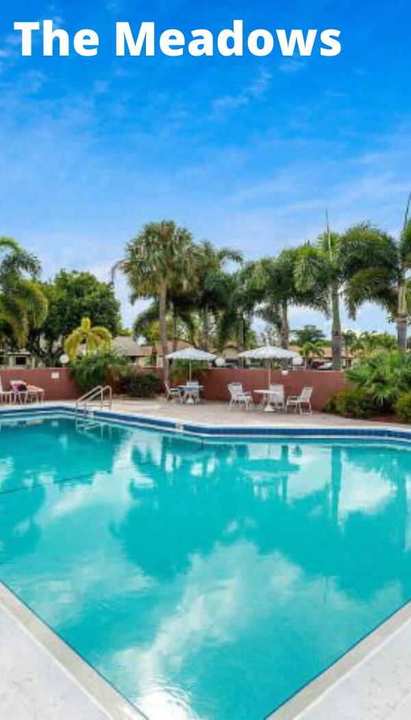 pool with a patio area and fence