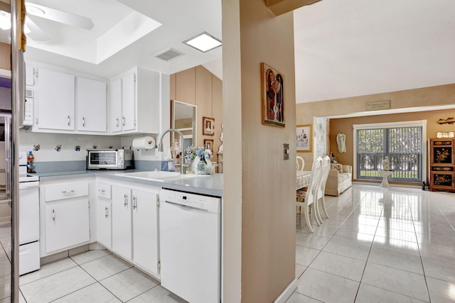 kitchen featuring a sink, white appliances, light tile patterned flooring, a toaster, and light countertops