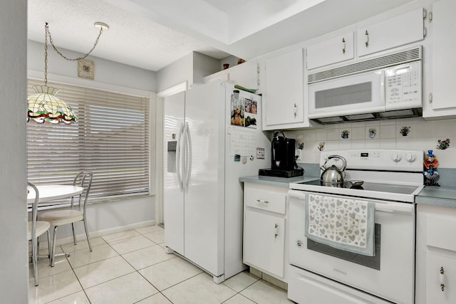 kitchen featuring decorative backsplash, light tile patterned flooring, white cabinets, white appliances, and a textured ceiling