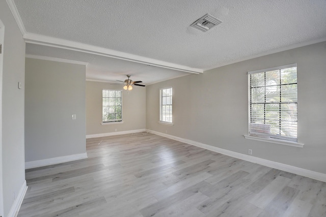 spare room with crown molding, light wood-style floors, and baseboards