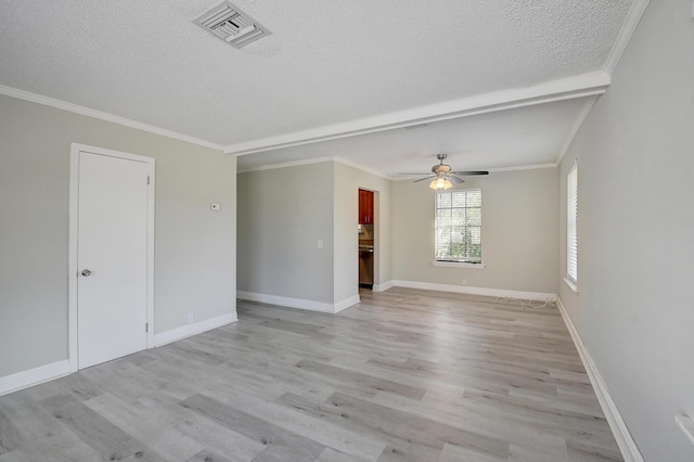 empty room featuring visible vents, crown molding, ceiling fan, light wood-type flooring, and a textured ceiling