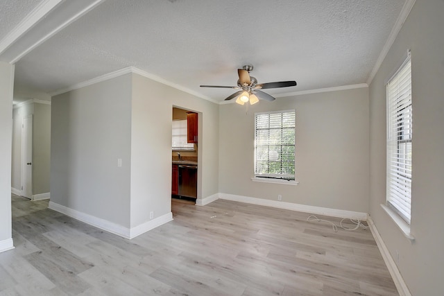 empty room featuring ornamental molding, a textured ceiling, light wood finished floors, baseboards, and ceiling fan