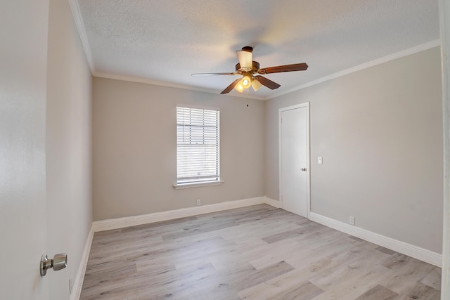 empty room featuring a textured ceiling, a ceiling fan, light wood finished floors, and ornamental molding