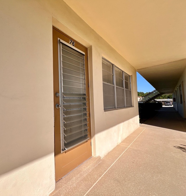 view of exterior entry featuring stucco siding