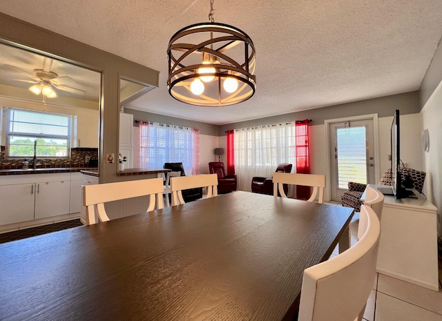 dining area featuring a textured ceiling and ceiling fan