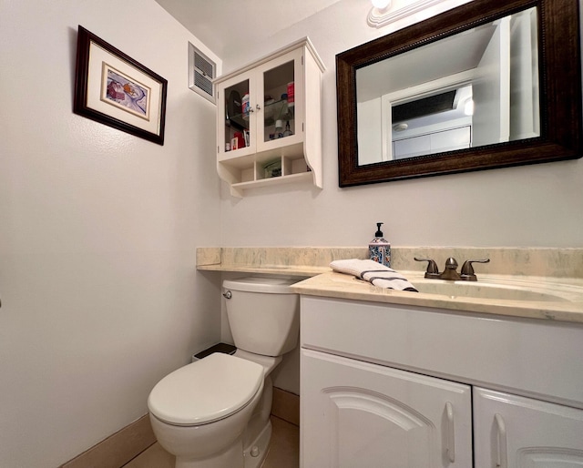 half bathroom featuring visible vents, toilet, and vanity