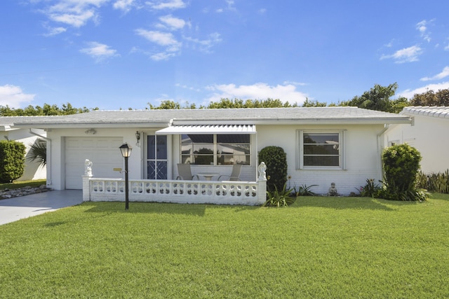 ranch-style home featuring a front lawn, a garage, driveway, and stucco siding