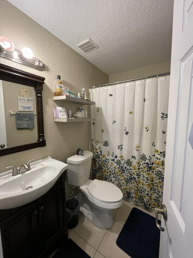 full bathroom with tile patterned flooring, visible vents, a textured ceiling, and a textured wall