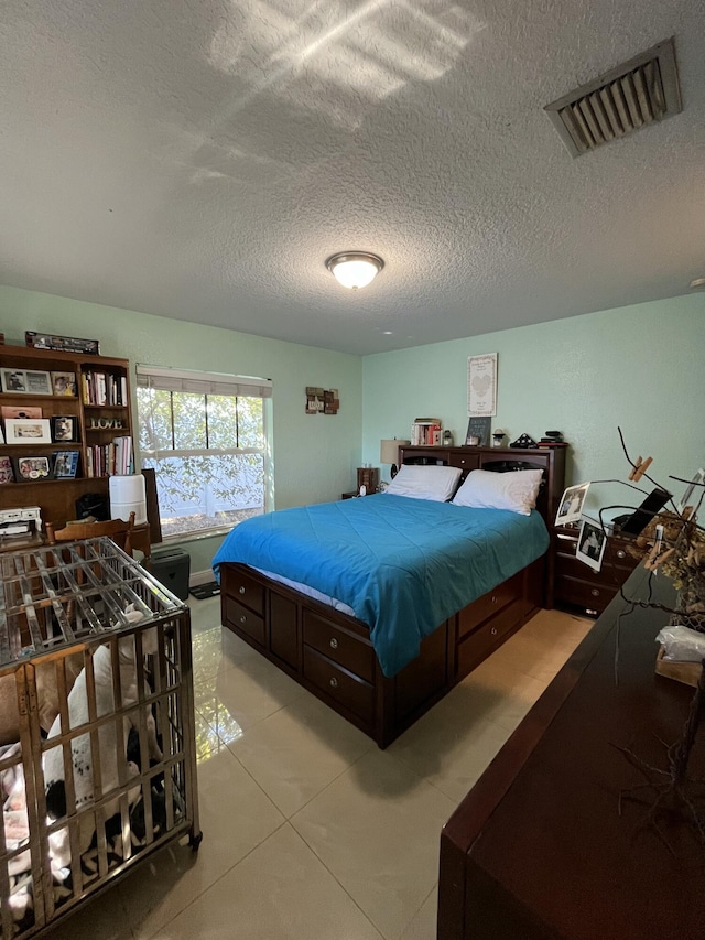 bedroom with visible vents and a textured ceiling