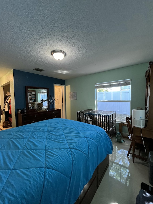 bedroom with visible vents and a textured ceiling