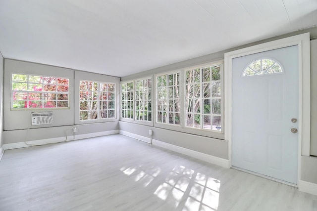 unfurnished sunroom with a wealth of natural light and a wall mounted AC