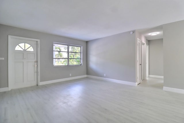 entrance foyer with light wood-style flooring and baseboards