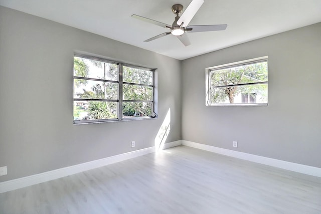 unfurnished room featuring wood finished floors, baseboards, and ceiling fan